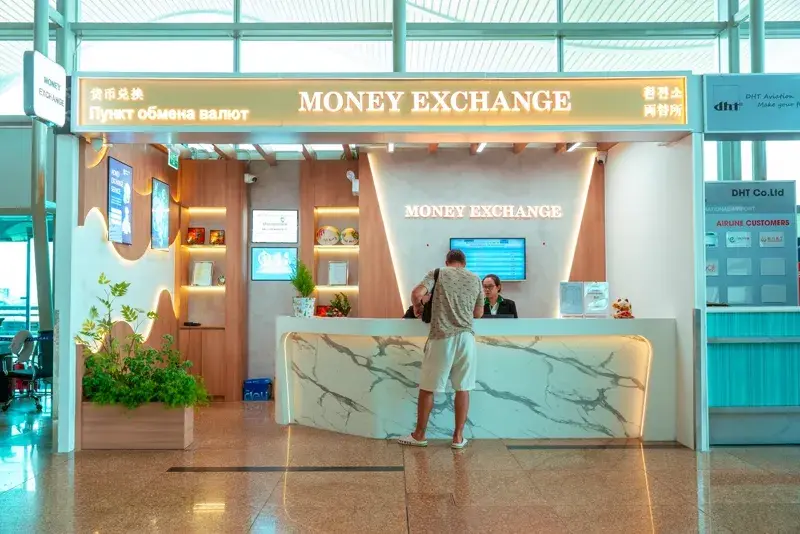 The Money Exchange counter in the international terminal (T2) at Cam Ranh Airport, with one customer at the desk