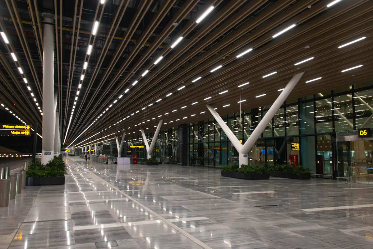 Sảnh đưa khách tầng 3 nhà ga T3 sân bay Tân Sơn Nhất về đêm, cột chữ V trắng và cửa vào D5, tháng 5/2025